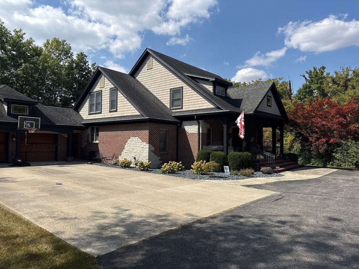 Wide cleaned concrete apron in front of a large Anderson home