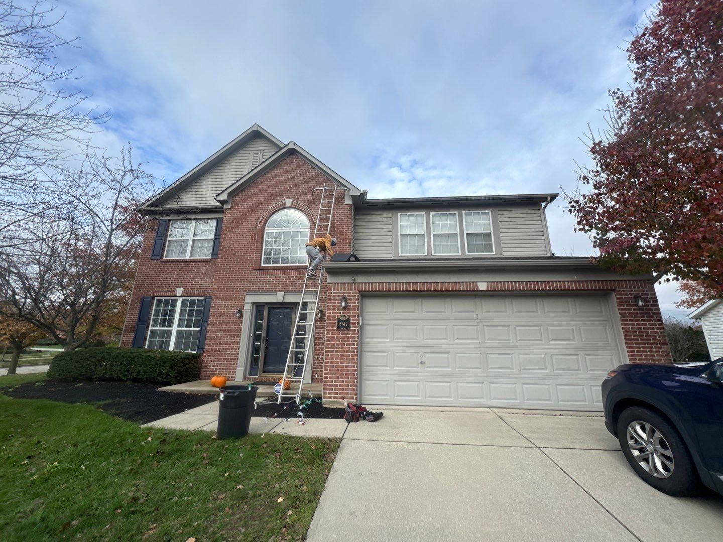 Brick and siding Carmel home with a cleaned drive