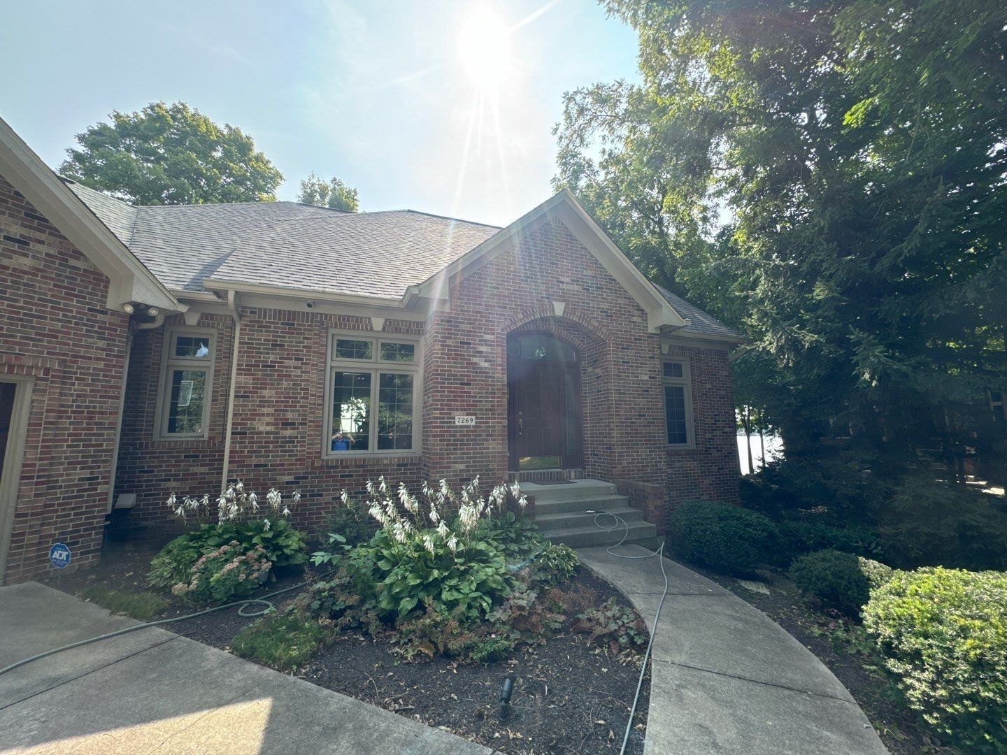 Brick Noblesville home with planted beds and a cleaned entry walk