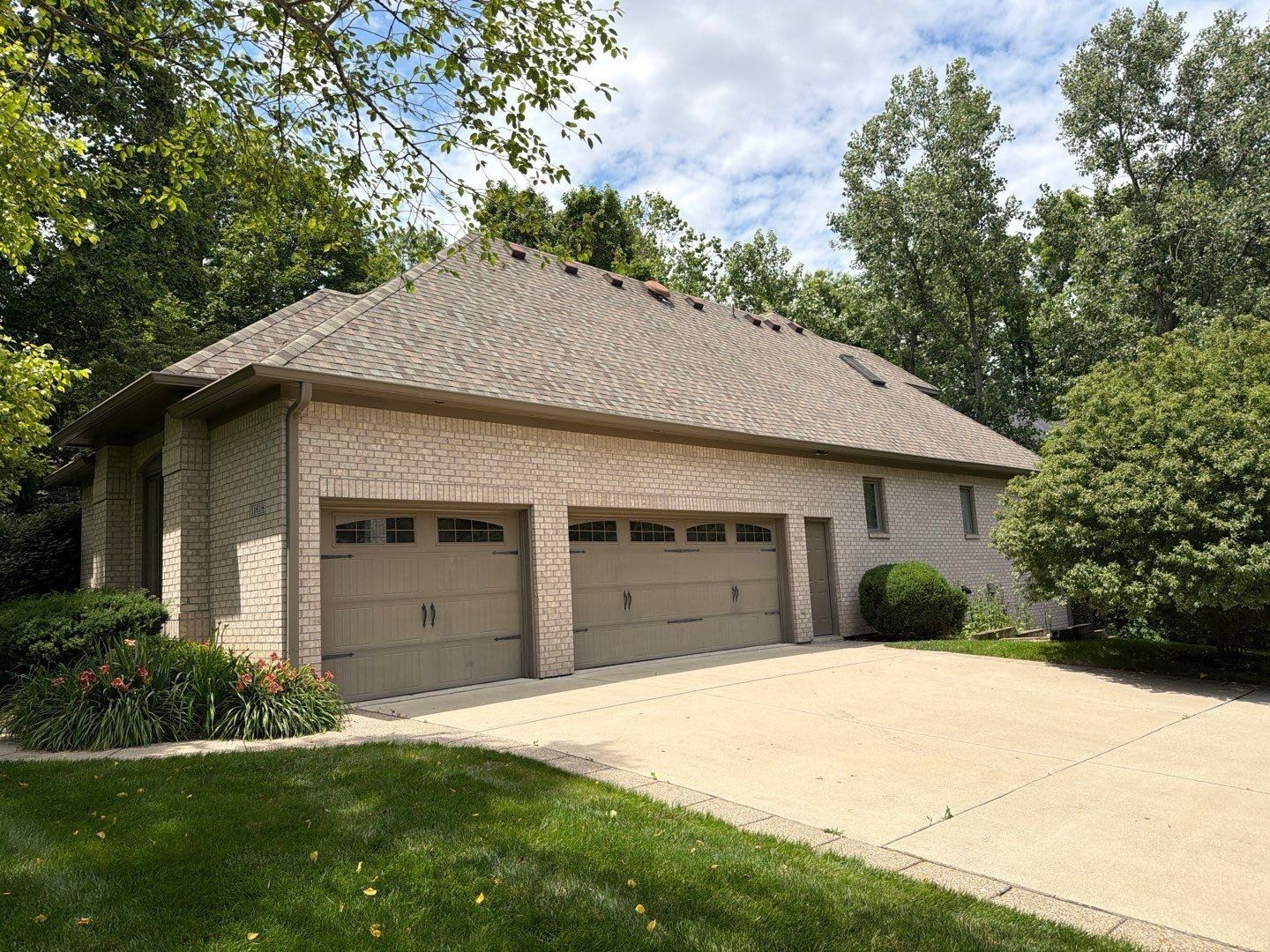 Zionsville home with a three car garage and a cleaned concrete drive