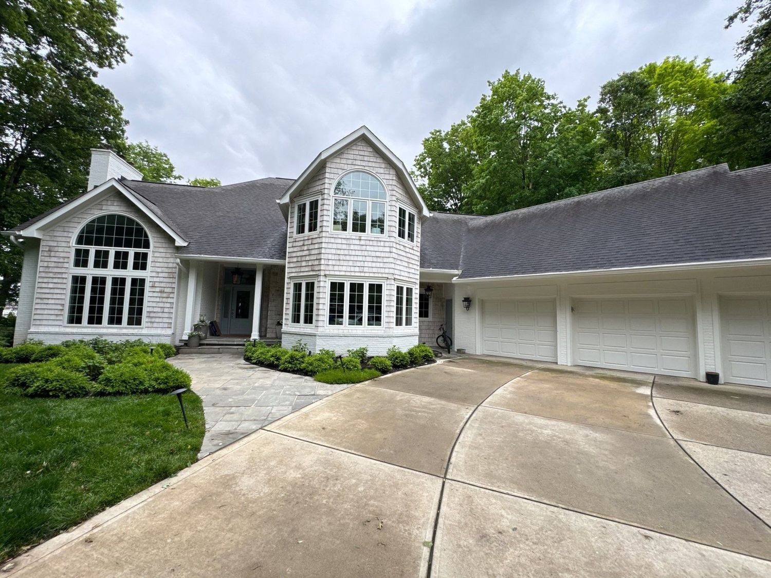 Large Cicero home with a curved cleaned concrete drive