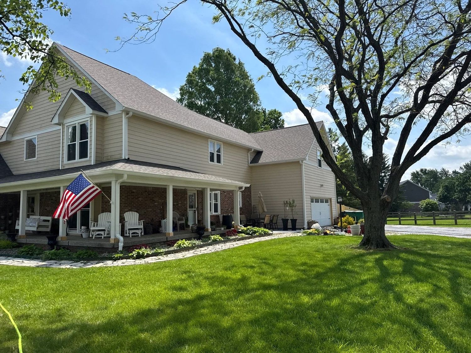 Carmel home with a covered porch and flag after a house wash