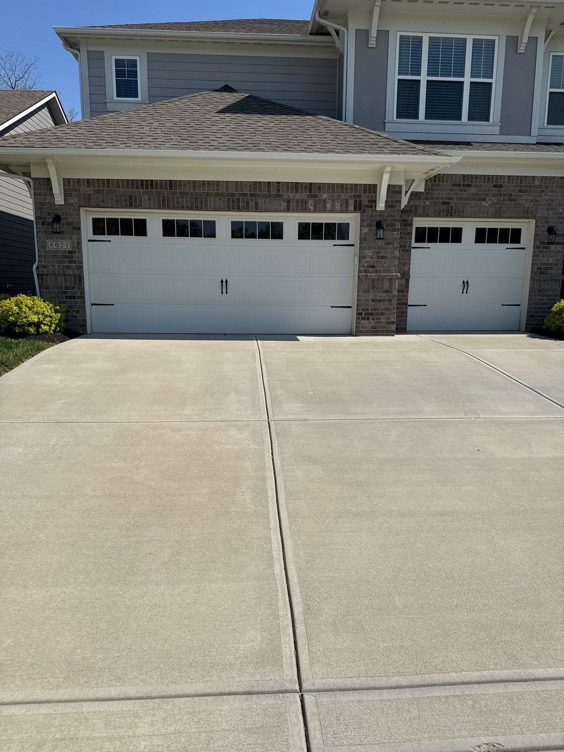 Cleaned concrete drive running up to a two car garage in Zionsville