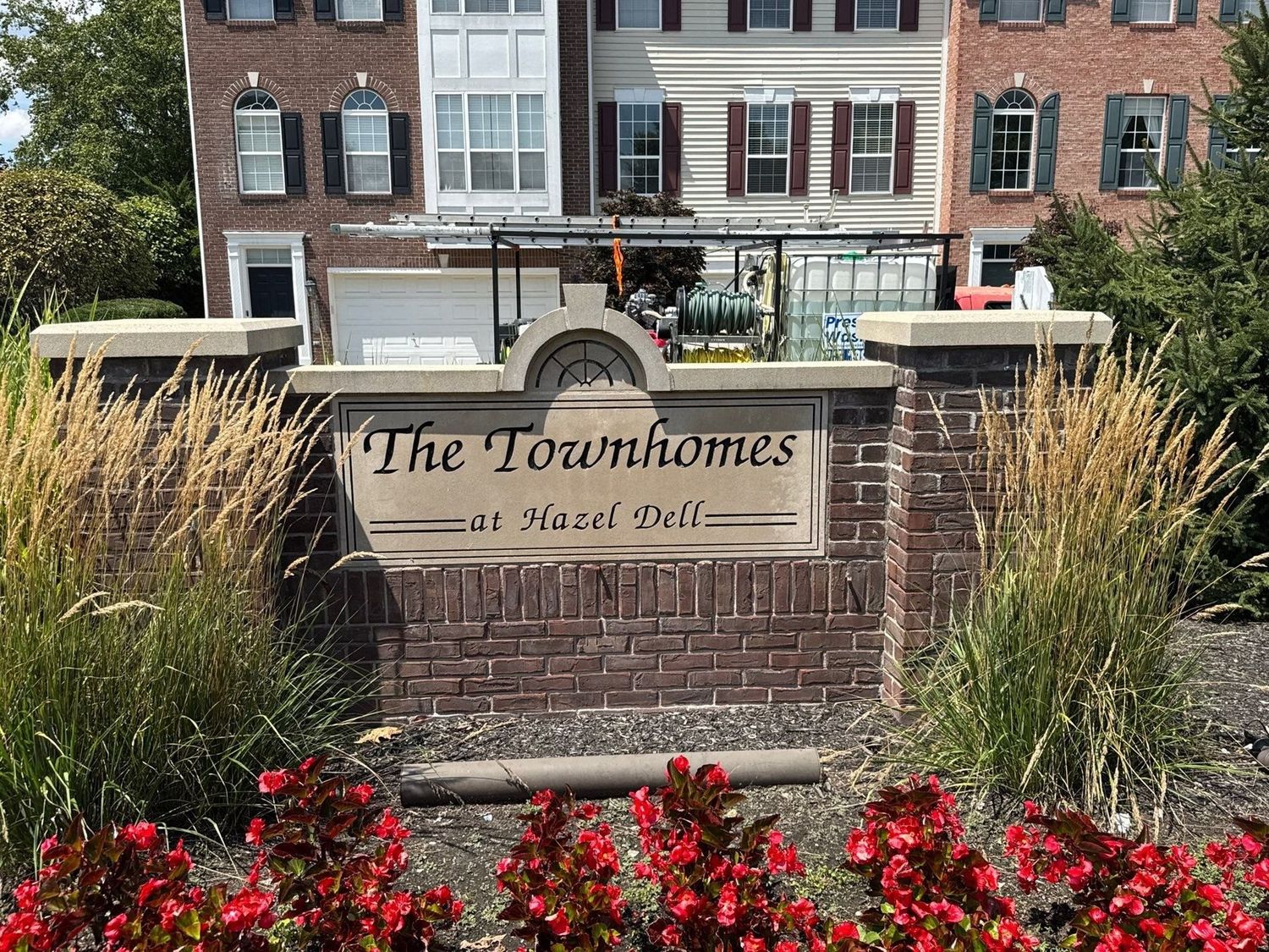 Brick entrance monument and landscaping at a Carmel townhome community after cleaning