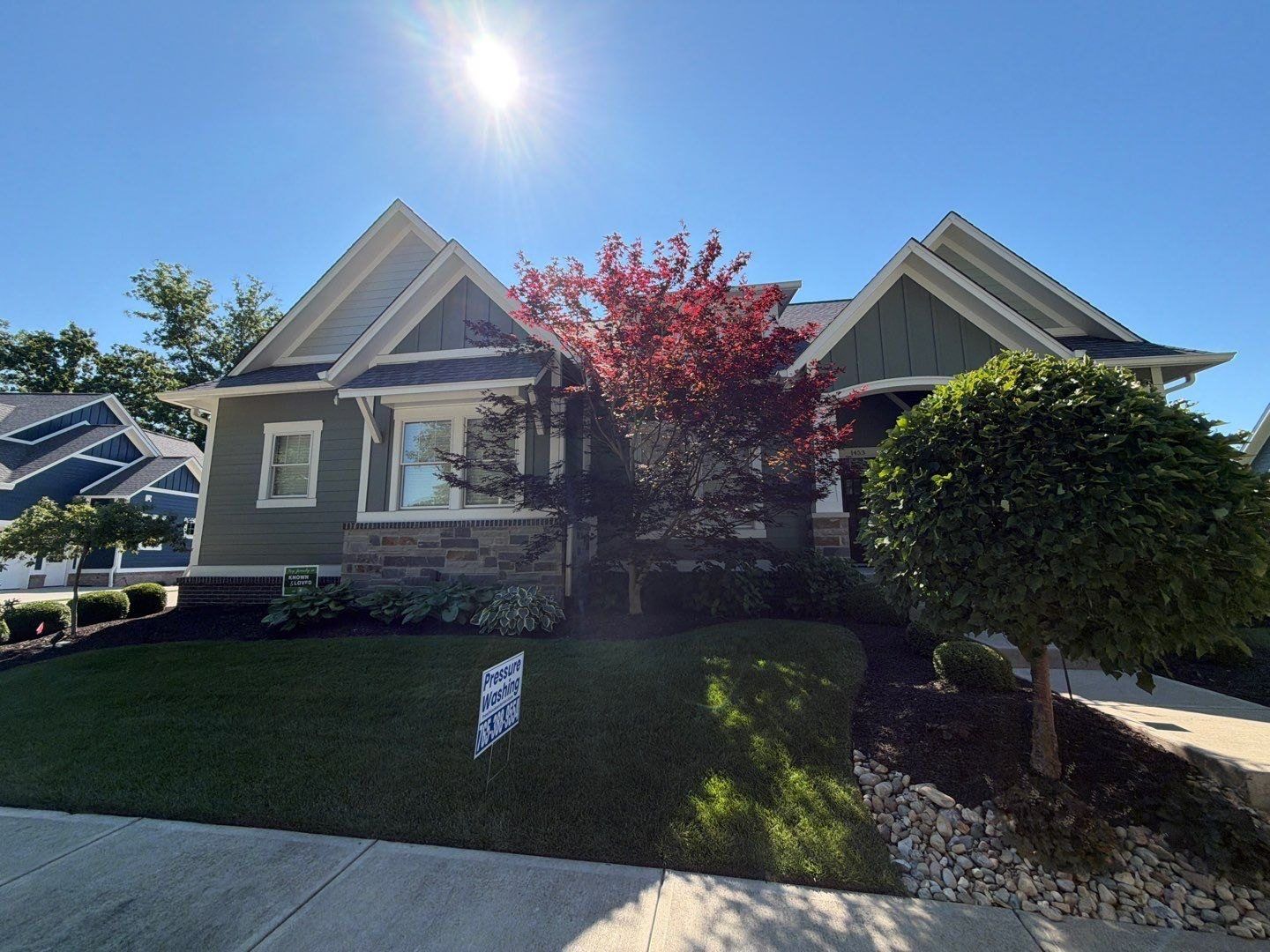 North side Indianapolis home with cleaned siding and a red maple in the front garden