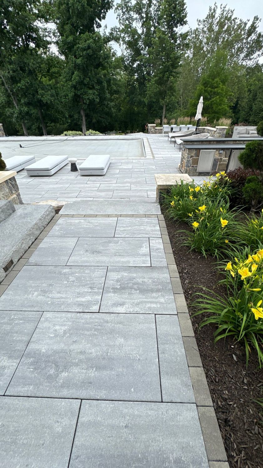 Cleaned paver walkway running between planted beds at a Zionsville home