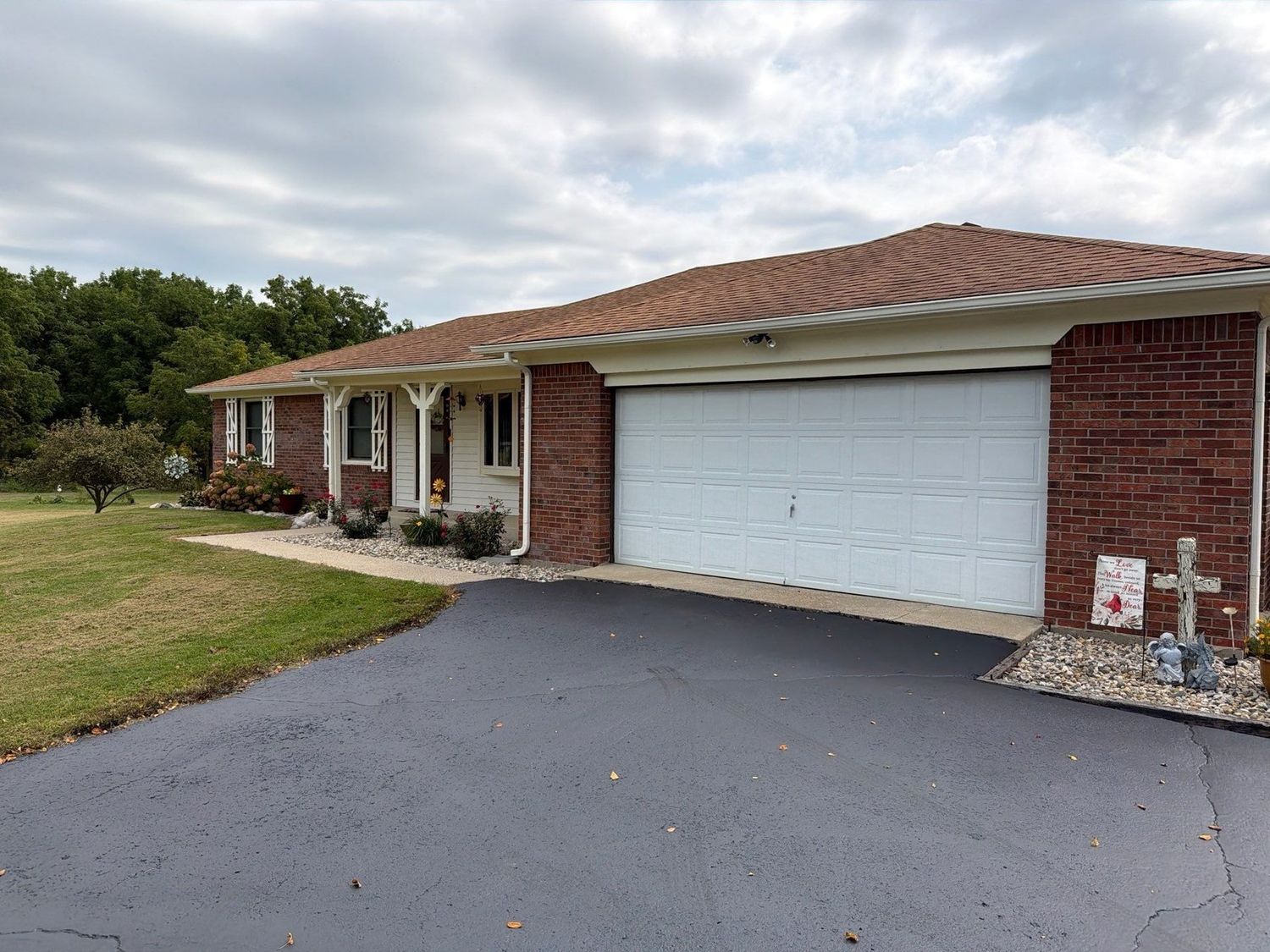 Brick ranch home in Sheridan with a cleaned asphalt drive