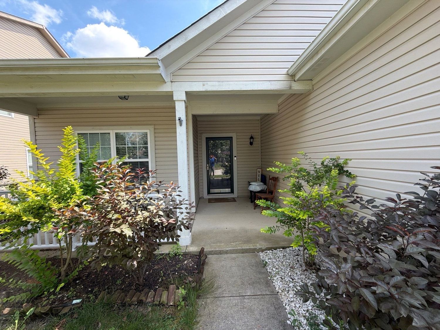 Noblesville home with cleaned siding, entry and planted beds