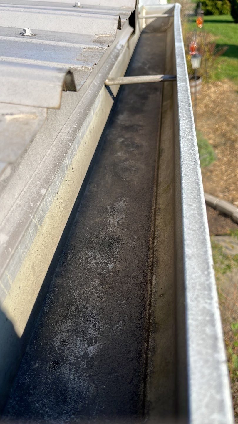 Gutter interior packed with debris before a clean out