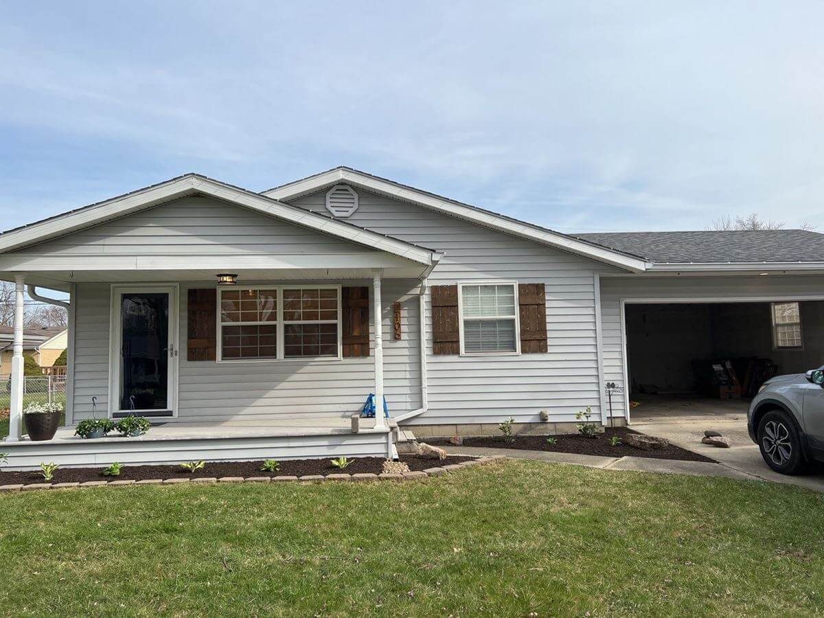 Indiana home with clean siding and a freshly cleaned concrete approach