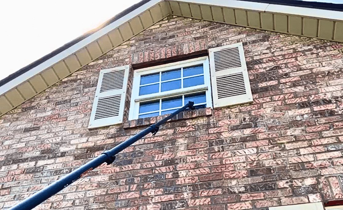 Purified water fed pole cleaning an upstairs window without pressure